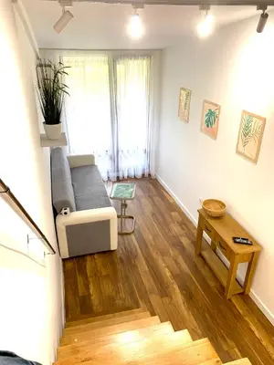 a living room with a couch and a table at Апартамент за гости in Varna City