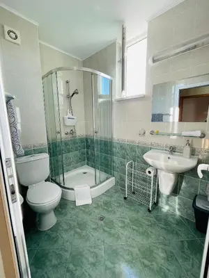 a bathroom with a toilet and a shower and a sink at Комплекс Бриз / Breeze Complex Apartments in Sunny Beach