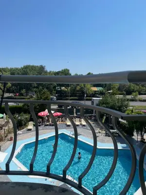 a view of a swimming pool from a balcony at Комплекс Бриз / Breeze Complex Apartments in Sunny Beach