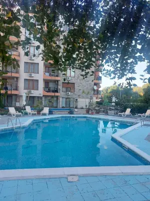 a large swimming pool in front of a building at Комплекс Бриз / Breeze Complex Apartments in Sunny Beach