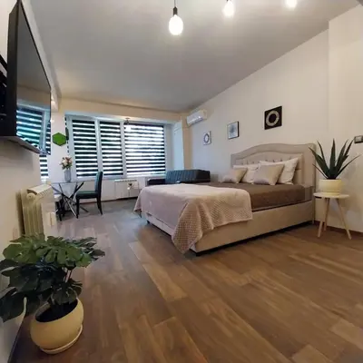 a bedroom with a bed and a table and chairs at Ika studio in Burgas City