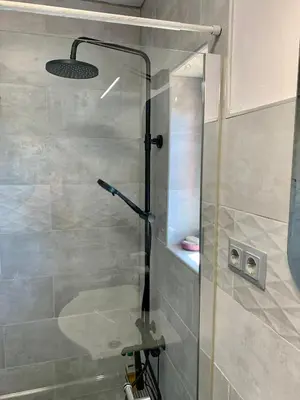 a shower with a glass door in a bathroom at Seaview Holiday - Черноморска почивка in Aheloy
