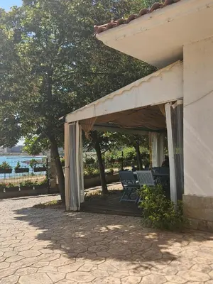 a patio with two chairs under a canopy at Seaview Holiday - Черноморска почивка in Aheloy