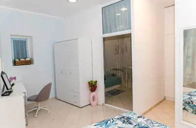 a bedroom with a bed and a desk at Луксозен апартамент Далия in Varna City