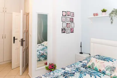 a bedroom with a bed and a mirror at Луксозен апартамент Далия in Varna City