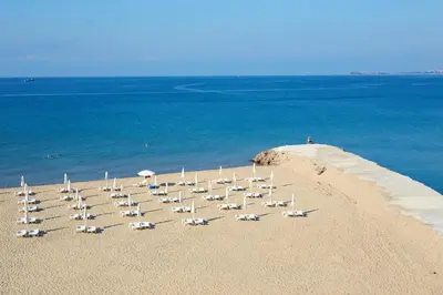 a group of chairs sitting on a beach at Hotel Amore Beach - All Inclusive in Elenite