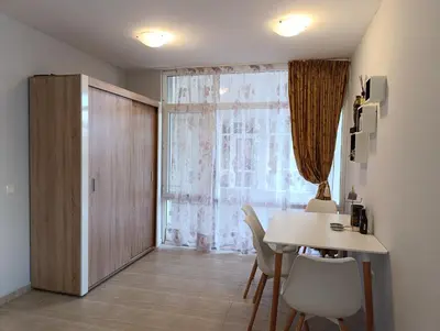 a dining room with a table and a window at Sun City Apartments in Sunny Beach