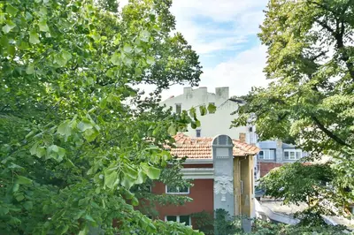 a view of a house through the trees at Hideout in heart of Varna with WiFi in Varna City