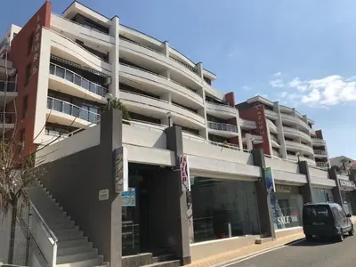 a large building with a car parked in front of it at Lazur Sea View, Sveti Vlas Beach in Sveti Vlas