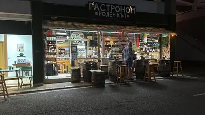 a man standing in front of a store window at Lazur Sea View, Sveti Vlas Beach in Sveti Vlas