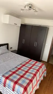 a bedroom with a bed with a checkered blanket at Lazur Sea View, Sveti Vlas Beach in Sveti Vlas