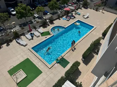 an overhead view of a swimming pool with people in it at Lazur Sea View, Sveti Vlas Beach in Sveti Vlas