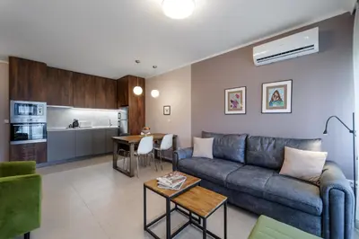 a living room with a couch and a table at Smokinia Sunrise - Kavatsi Beach, Sozopol in Sozopol