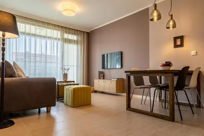 a living room with a table and a couch at Smokinia Sunrise - Kavatsi Beach, Sozopol in Sozopol