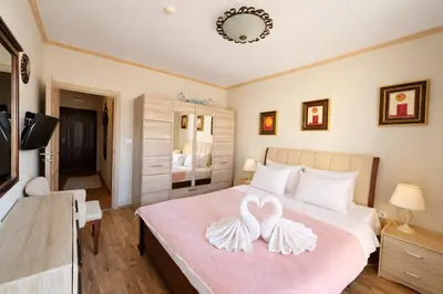 a bedroom with a bed with two hearts on it at Royal Bay-I Seaview Apartment in Sveti Vlas