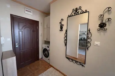 a mirror on a wall next to a door at Royal Bay-I Seaview Apartment in Sveti Vlas