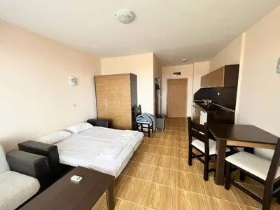 a bedroom with a bed and a desk and a piano at Magic Dreams St Vlas in Sunny Beach