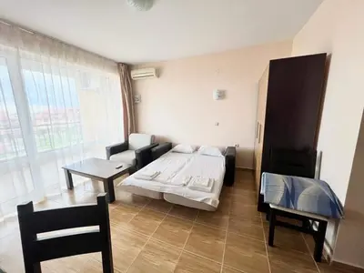a room with a bed and a table in it at Magic Dreams St Vlas in Sunny Beach