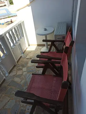 two chairs and a table on a balcony at Hotel Gamartata in Duni