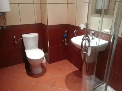 a bathroom with a toilet and a sink at Menada Green Hills Apartments in Sozopol