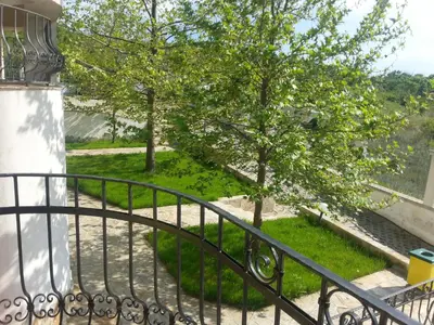 a view from the balcony of a house with a tree at Menada Green Hills Apartments in Sozopol
