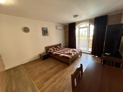 a bedroom with a bed and a large window at Apartments Amara Sunny Beach in Sunny Beach