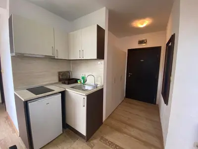 a small kitchen with a sink and a counter at Apartments Amara Sunny Beach in Sunny Beach