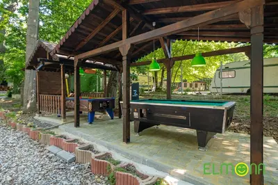 a pool table under a pavilion with a ping pong table at Elmona Villas in Kamchia