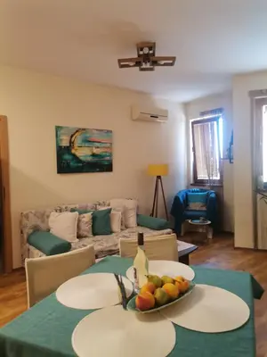 a living room with a table with a bowl of fruit on it at Апартамент в Oasis beach Kamchia - Лунна пътека in Dolen Bliznak