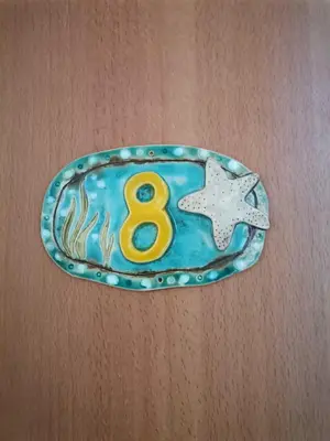 a metal plate with a number eight and a star at Апартамент в Oasis beach Kamchia - Лунна пътека in Dolen Bliznak