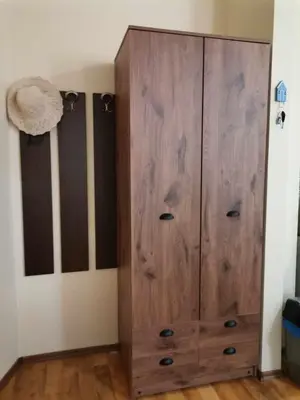 a large wooden cabinet in a room at Апартамент в Oasis beach Kamchia - Лунна пътека in Dolen Bliznak