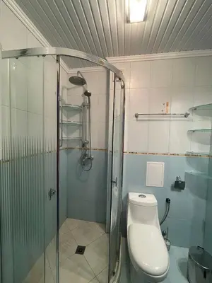 a bathroom with a toilet and a glass shower at Apart hotel Gallery B in Sunny Beach