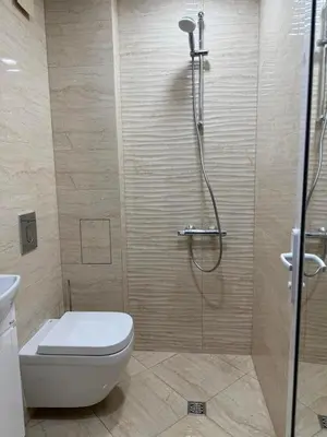 a bathroom with a shower with a toilet and a glass shower at Apart hotel Gallery B in Sunny Beach