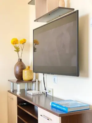 a flat screen tv hanging on a wall at Alonia - your Burgas shelter by the park and beach in Burgas City