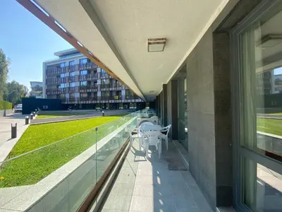 a balcony of a building with a table and chairs at PARADISO 'В' 111 Large Apartment Nessebar in Nesebar