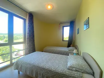 a bedroom with two beds and a large window at AMADEUS 1 - 13B Large Two Bedroom Apartment in Sunny Beach
