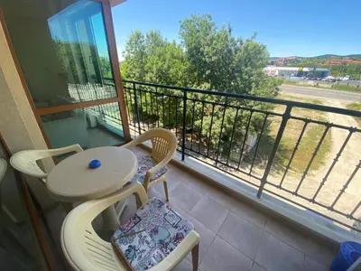 a balcony with a table and chairs and a view of a street at AMADEUS 1 - 13B Large Two Bedroom Apartment in Sunny Beach