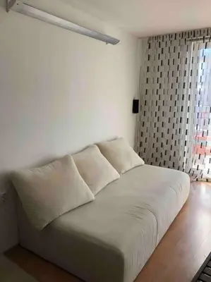 a white bed in a room with a window at Квартира у моря in Sveti Vlas