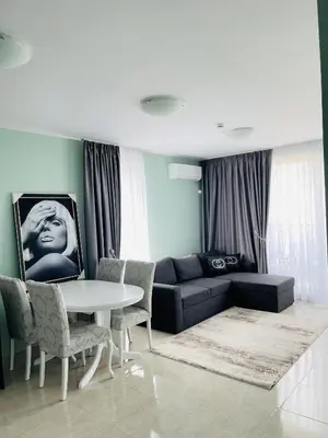 a living room with a couch and a table and chairs at Admiral Plaza in Sunny Beach
