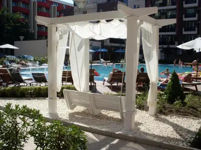 a white gazebo in front of a pool at Admiral Plaza in Sunny Beach
