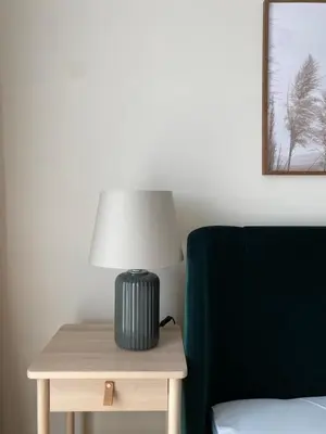 a lamp sitting on a table next to a chair at Ravda Bliss with a pool in Ravda
