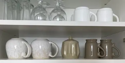 a row of vases and glasses on a shelf at Ravda Bliss with a pool in Ravda