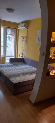 a bedroom with a bed in a room at Илеа апартамент in Burgas City