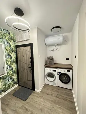 a laundry room with a washing machine and a washer at Varna Cathedral Boutique Apartment in Varna City