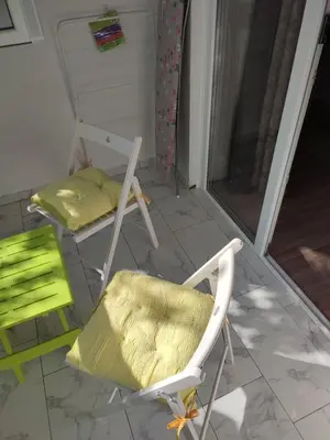 two chairs and a bed on a porch at Desafinado in Burgas City