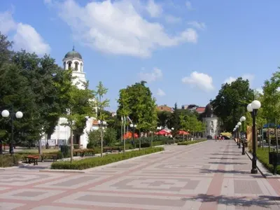 a street in a park with a building in the background at Family Hotel Electra in Pomorie