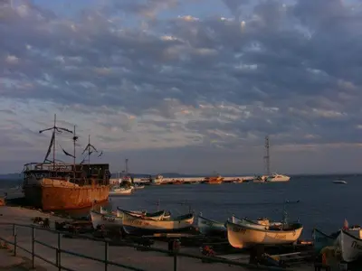 a group of boats sitting on the shore of the water at Family Hotel Electra in Pomorie
