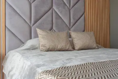 a bed with two pillows on top of it at Apartament Harmony in Sunny Beach
