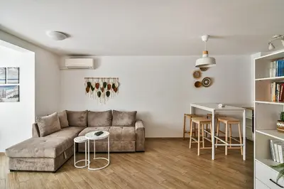 a living room with a couch and a table at Central flat Wi-Fi & streaming in Varna City