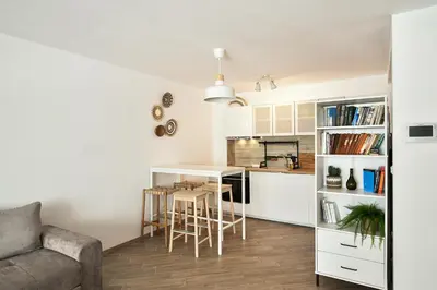 a kitchen and living room with a table and chairs at Central flat Wi-Fi & streaming in Varna City